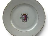 a white plate with a coat of arms on it