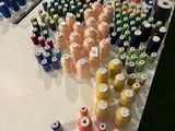 many spools of thread sitting on a table