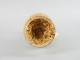 a close up of a gold ring on a white surface