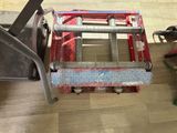 a picture of a hand truck with tools on the floor