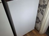 an image of a small white refrigerator in a kitchen