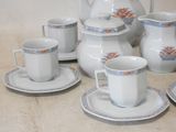 a lot of cups and saucers sitting on a table
