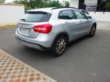 a silver car that is parked on the side of the road