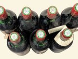 bottles of wine are lined up in a row on a table