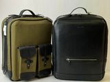 two pieces of luggage sitting next to each other on a table