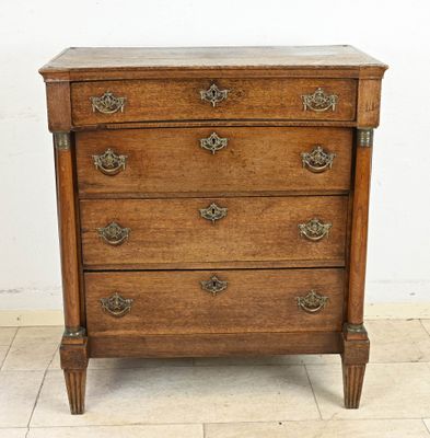 an old wooden chest of drawers on a tiled floor