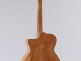 an acoustic guitar hanging from a string on a white background