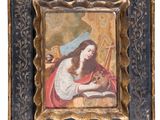 un tableau représentant une femme en train de lire un livre, dans un cadre doré