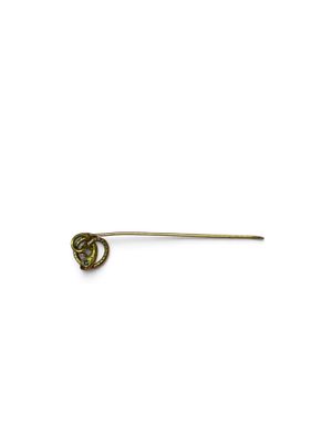 an image of a gold pin with a green stone in the middle