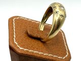 a gold ring sitting on top of a brown box