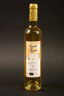 a bottle of wine sitting on top of a black table