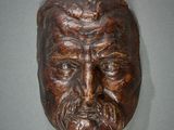 sculpture of a man with a beard and mustache on a wall