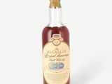 a bottle of royal reserve whisky on a white background