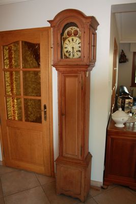 a grandfather clock sitting in the corner of a room