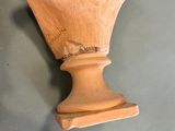 a wooden bust of a woman on display on a table