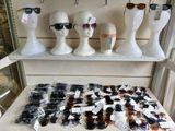 several mannequin heads and sunglasses are on display in a store