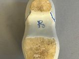 a white shoe with blue writing on it on a table