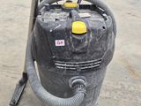 a vacuum that is sitting on the floor in the garage
