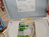 a person holding a box with some green and white wires in it