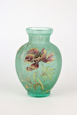 a green vase with a flower painted on it