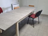 a table and two chairs in a room with tile flooring