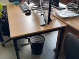 a desk with two computer monitors and a chair in front of it