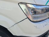 a close up of a white van parked in a parking lot