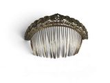 a hair comb that is sitting on a white surface
