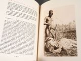 an open book with a black and white photo of a man with a goat