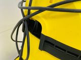 a yellow backpack with a black cord attached to it