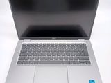 an open laptop computer sitting on top of a white table