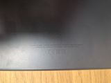 a close up of the back of a black laptop computer