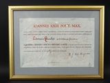 gold frame displaying a document with a red writing on it
