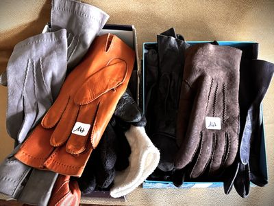 several pairs of gloves are sitting in a box on a table