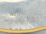 a close up of a silver plate with writing on it
