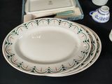 a table with plates and bowls on it and a box of salt and pepper shakers on the table