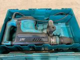 a blue box with a drill in it on the floor
