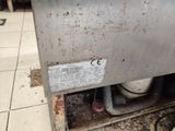an image of a dirty dishwasher in a dirty kitchen