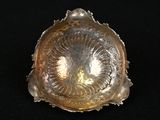 an image of a silver shell shaped object on a black surface