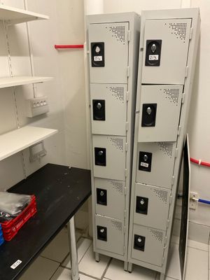 several metal lockers are stacked on top of each other in a room
