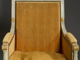 a close up of a chair with a yellow upholstered seat