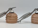 two salt and pepper shakers sitting next to each other