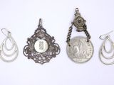 several different types of jewelry are displayed on a white surface