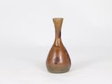 brown vase on a white surface with a white background