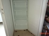 a tall cabinet in the corner of a kitchen