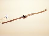 a silver bracelet with a black bead on it