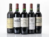six bottles of wine are lined up in a row on a white surface