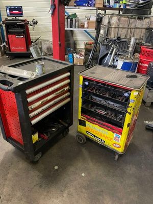 two tools are sitting on a cart in a garage