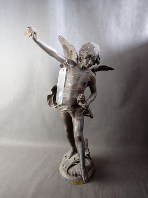 a statue of a boy with a bird on his arm