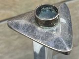 a metal object with a ring on top of it